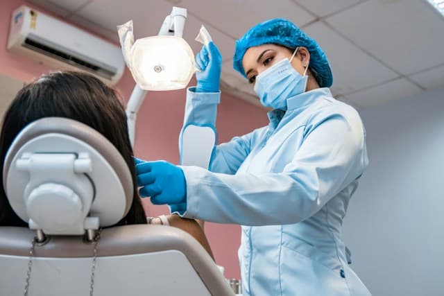 Dentist whitening a patient's teeth