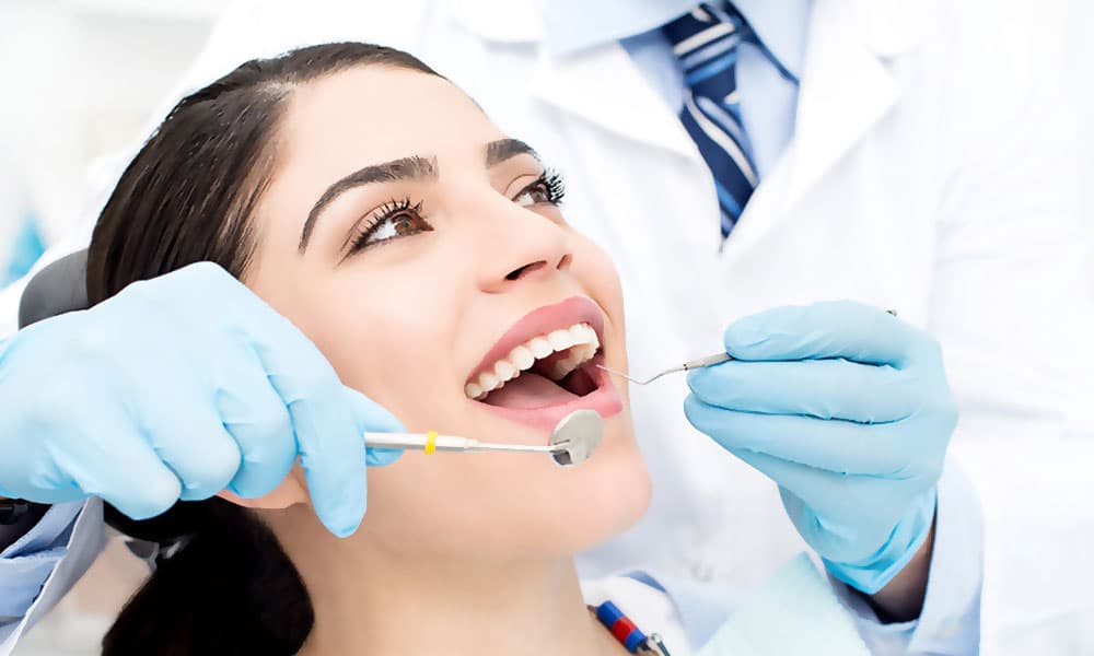 Dental assistant adjusting a treatment light
